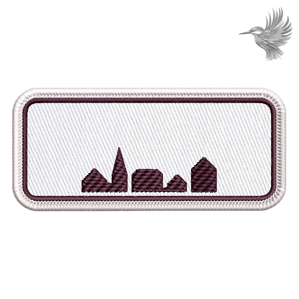 Broderet lap formet som et byskilt