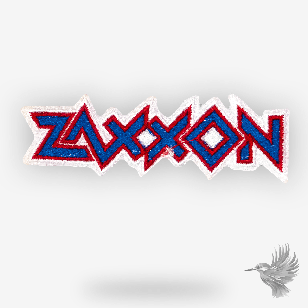 Zaxxon logo patch strygemærke broderet retro gamingmærke i blå, rød og hvid med klassisk arkadestil.